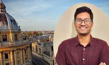 A portrait photograph of a young man of Asian descent wearing glasses and a mauve shirt. The portrait is overlaid against an image of the skyline of Oxford University historic buildings.